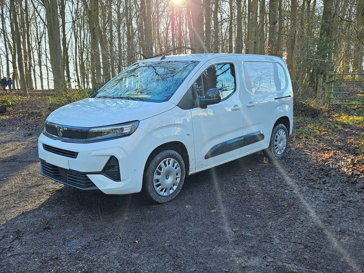 White service van parked on a country road